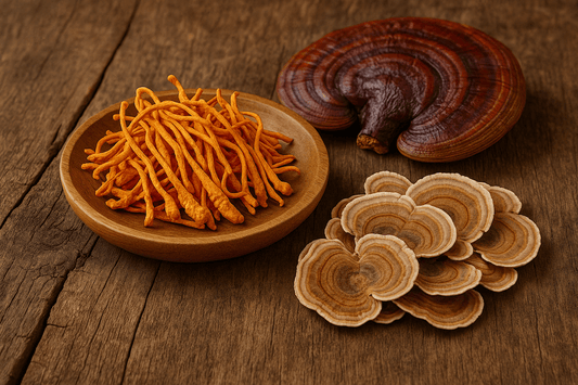 Cordyceps, Reishi, and Turkey Tail mushrooms displayed on rustic wooden surface, known for boosting endurance and stamina naturally
